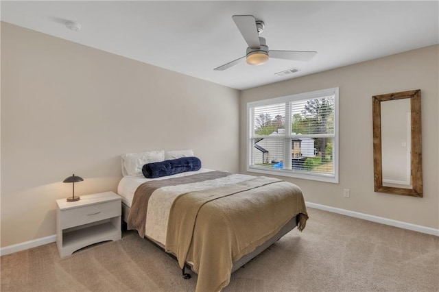 bedroom featuring baseboards, visible vents, ceiling fan, and light colored carpet