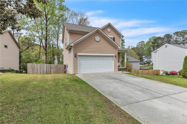 view of front of home featuring driveway, a garage, fence, and a front yard