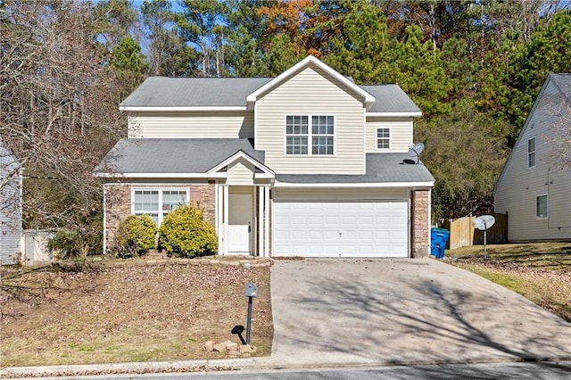 traditional-style home with a garage, concrete driveway, stone siding, and fence