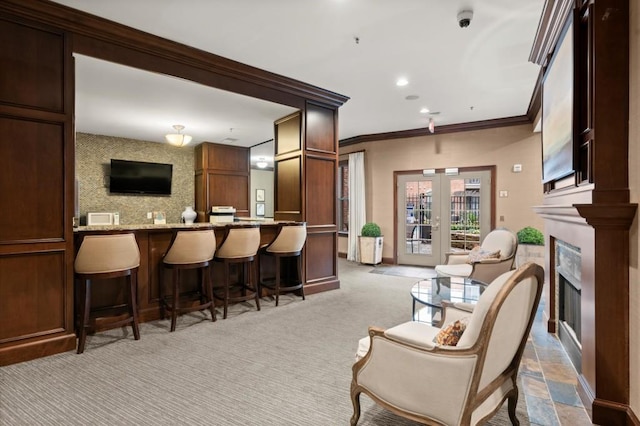 interior space featuring baseboards, ornamental molding, french doors, a fireplace, and recessed lighting