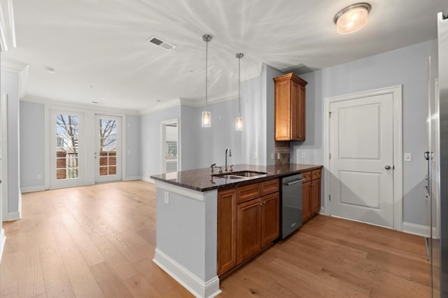 kitchen with a sink, visible vents, stainless steel dishwasher, light wood-type flooring, and brown cabinets