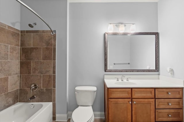 bathroom with toilet, shower / washtub combination, vanity, and baseboards