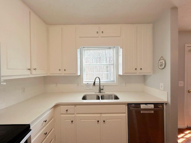 kitchen with dishwasher, light countertops, white cabinetry, and a sink