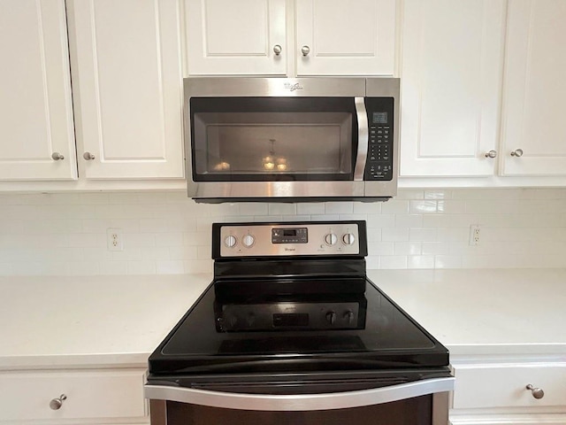 kitchen with light countertops, white cabinets, and appliances with stainless steel finishes