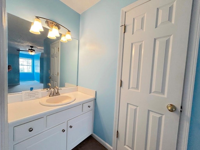 bathroom featuring baseboards and vanity