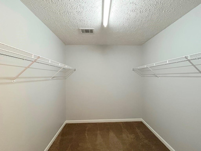 walk in closet with carpet flooring and visible vents