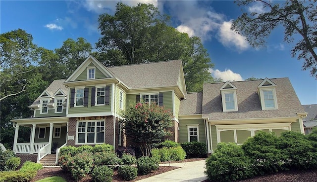 view of front of home with covered porch and a garage