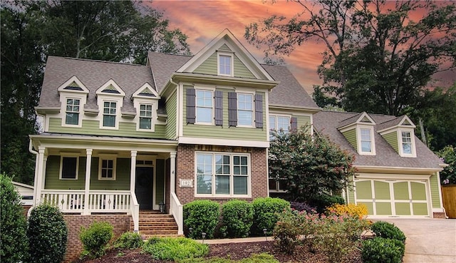 view of front of property with a garage and covered porch