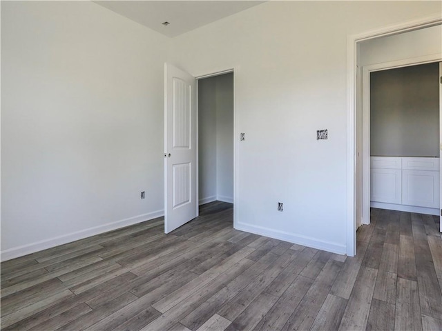 unfurnished bedroom with dark hardwood / wood-style floors