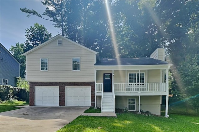 1011 Darvin Ln NW, Kennesaw, GA 30144 - tri-level home featuring a porch, a front lawn, an attached garage, driveway, and brick siding