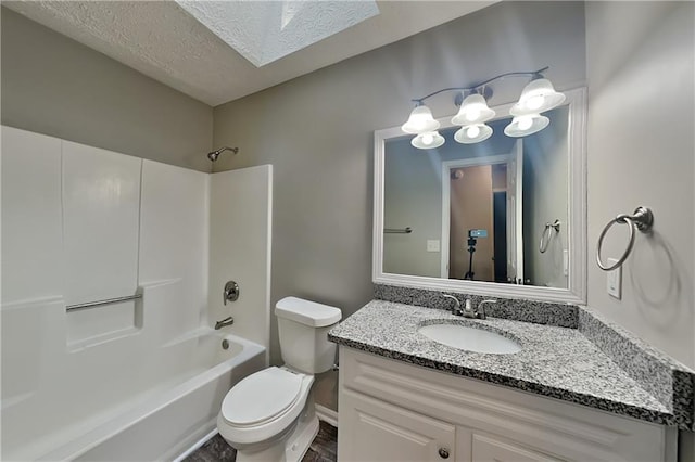 1011 Darvin Ln NW, Kennesaw, GA 30144 - full bathroom featuring vanity,  shower combination, a skylight, a textured ceiling, and wood finished floors