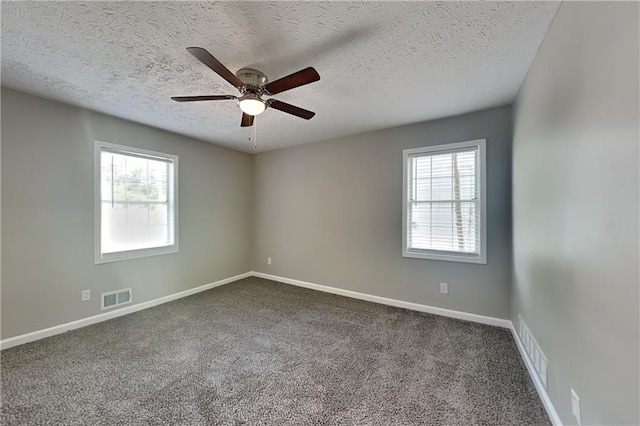 1011 Darvin Ln NW, Kennesaw, GA 30144 - unfurnished room with a textured ceiling, dark colored carpet, and a ceiling fan