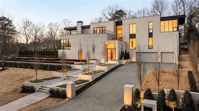 modern home featuring a garage and a balcony