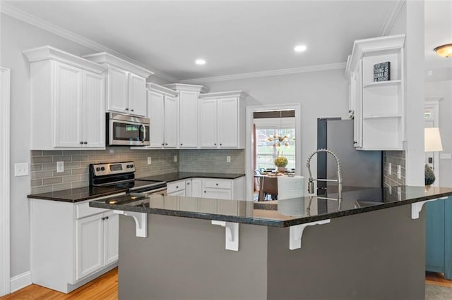 kitchen featuring open shelves, stainless steel appliances, a peninsula, and white cabinets