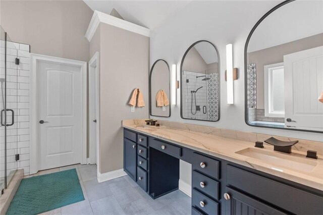 full bath featuring tile patterned floors, a sink, double vanity, a stall shower, and vaulted ceiling