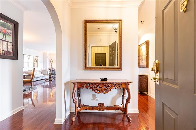 hallway with hardwood / wood-style floors and ornamental molding