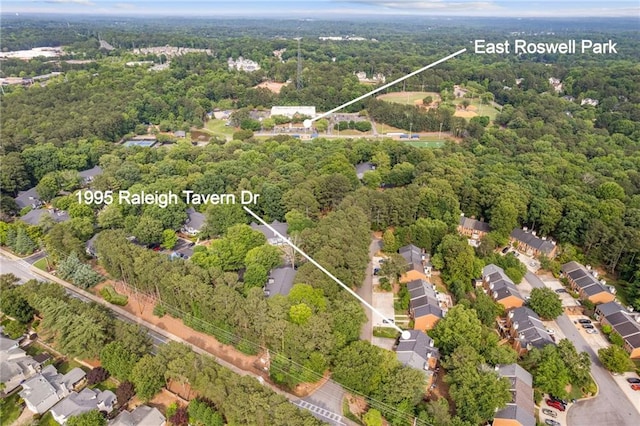 1995 Raleigh Tavern Dr, Roswell, GA 30076 - aerial view of property and surrounding area with a heavily wooded area, nearby suburban area, and property parcel outlined