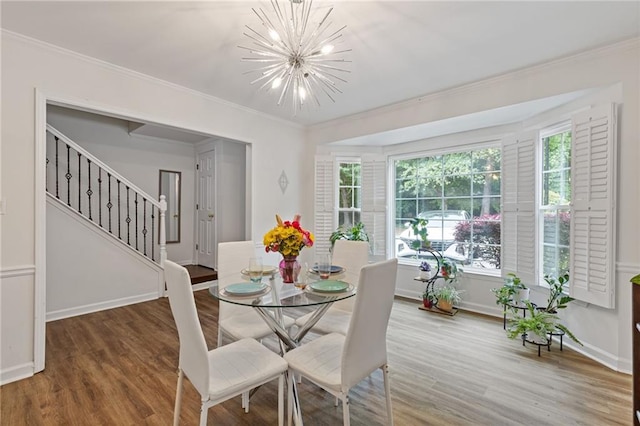 1995 Raleigh Tavern Dr, Roswell, GA 30076 - dining space featuring crown molding, a chandelier, wood finished floors, stairway, and baseboards