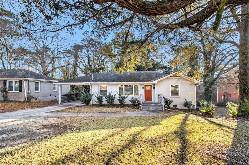 ranch-style home featuring a front yard and a carport