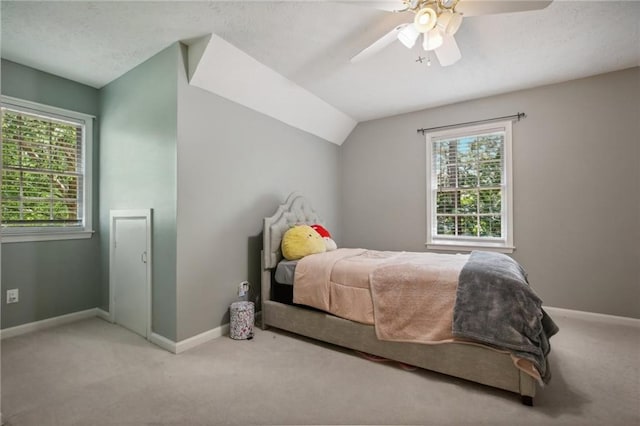 bedroom featuring ceiling fan, carpet floors, and vaulted ceiling