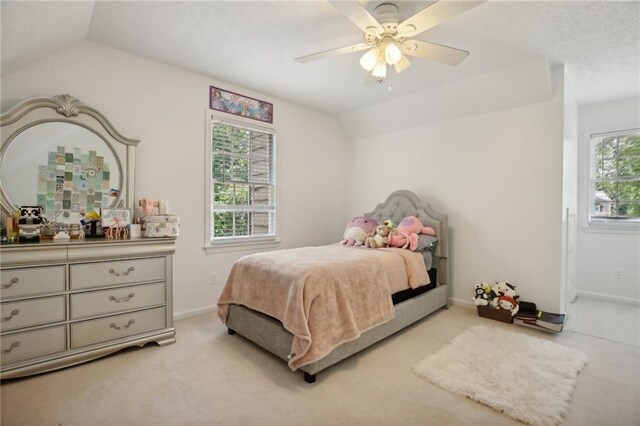 carpeted bedroom featuring ceiling fan and vaulted ceiling