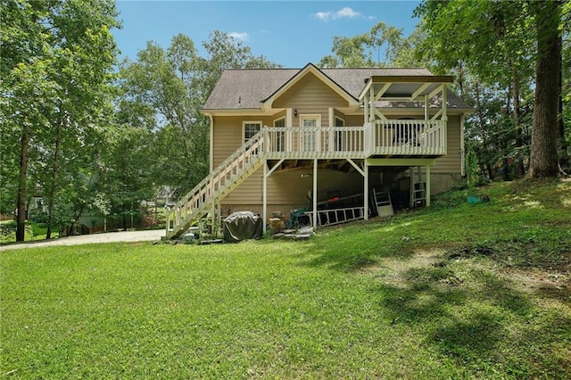 rear view of property with a yard and a deck