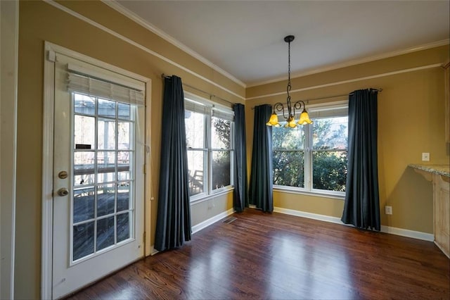 unfurnished dining area featuring a notable chandelier, crown molding, and dark hardwood / wood-style floors