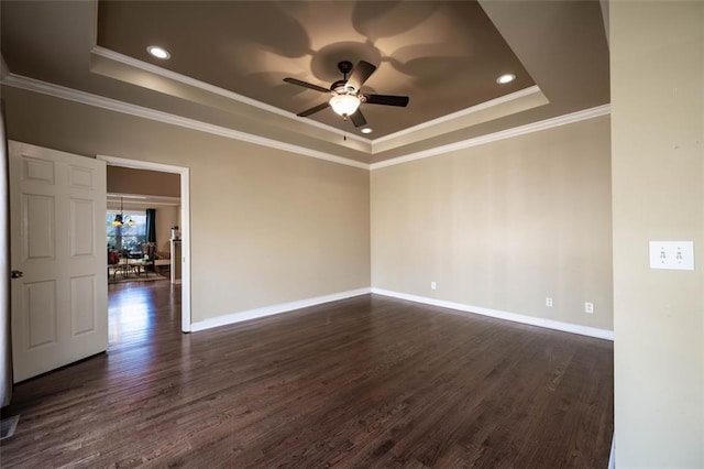 spare room with ceiling fan with notable chandelier, a raised ceiling, ornamental molding, and dark hardwood / wood-style flooring