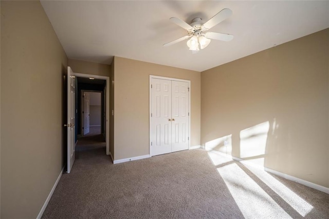 unfurnished bedroom featuring ceiling fan, a closet, and carpet