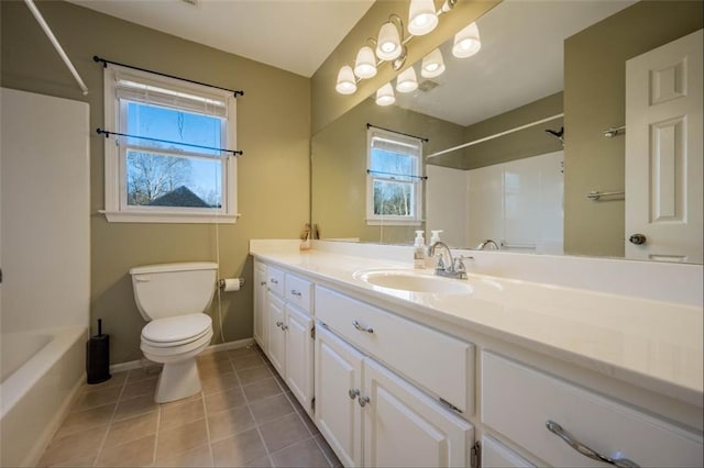 bathroom featuring toilet, vanity, and tile patterned floors