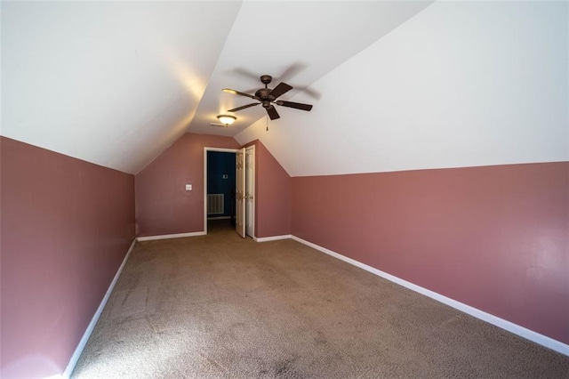 additional living space with ceiling fan, vaulted ceiling, and carpet flooring