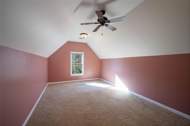 additional living space with ceiling fan, vaulted ceiling, and carpet flooring