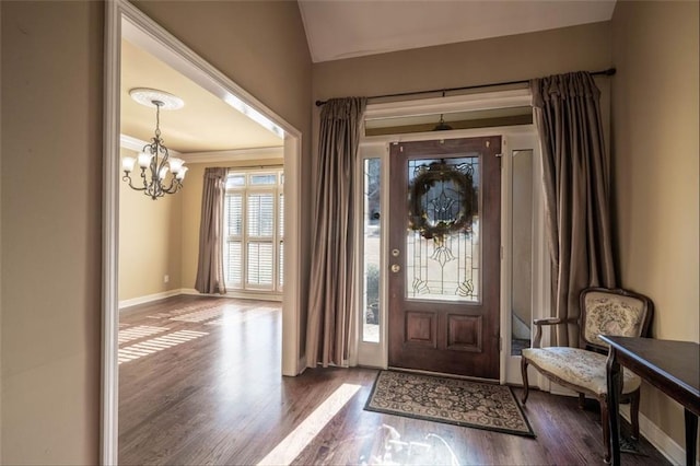 foyer featuring lofted ceiling, dark hardwood / wood-style flooring, and a chandelier