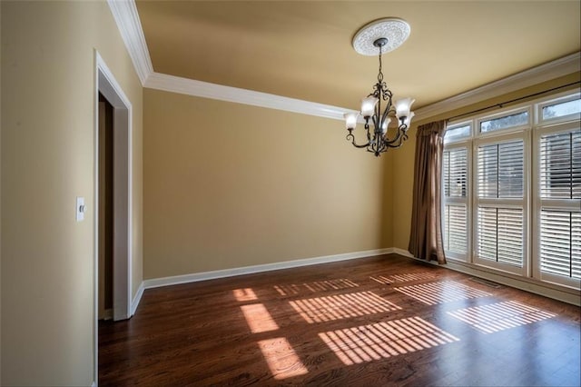 unfurnished room featuring an inviting chandelier, crown molding, and dark hardwood / wood-style floors