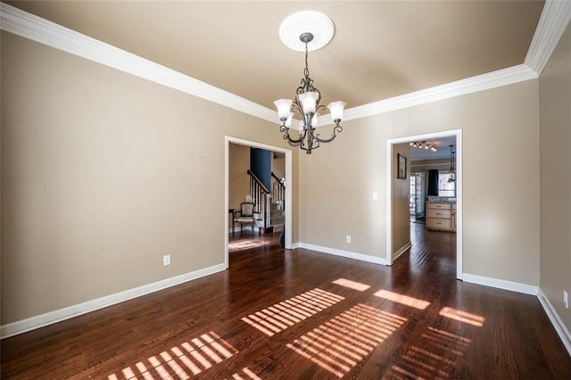 unfurnished dining area featuring a notable chandelier, dark wood-type flooring, and ornamental molding