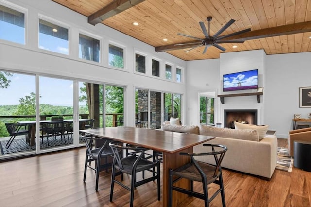 897 Faraday Dr, Ellijay, GA 30540 - dining area with a wooden ceiling with exposed beams, plenty of natural light, a ceiling fan, a towering ceiling, and a large fireplace