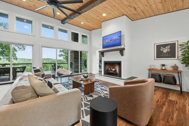 897 Faraday Dr, Ellijay, GA 30540 - living area with a wooden ceiling with exposed beams, a high ceiling, wood finished floors, a large fireplace, and a ceiling fan