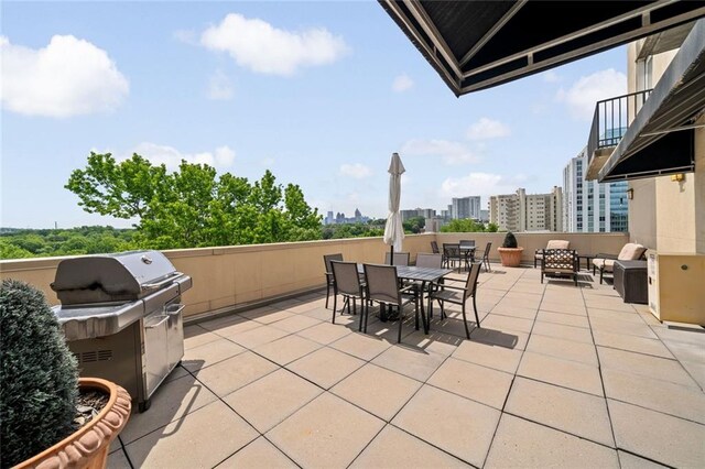view of patio / terrace with a city view and outdoor dining space