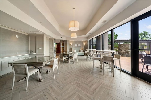 dining space featuring a tray ceiling