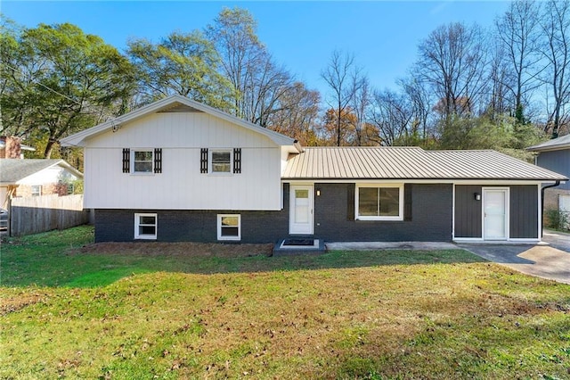 tri-level home with a front yard