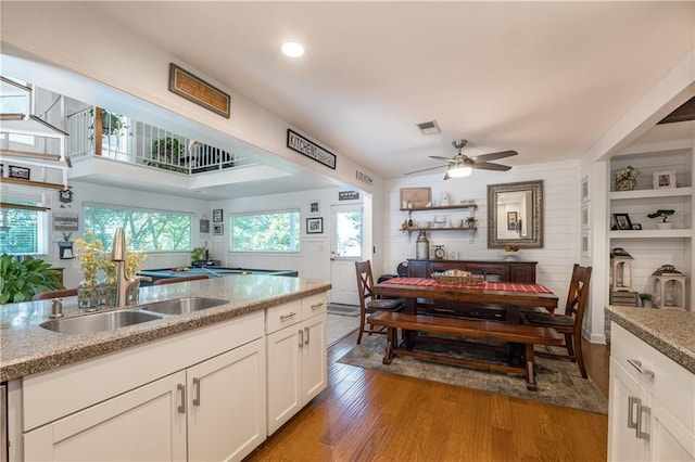 4442 Academy St, Acworth, GA 30101 - kitchen featuring wood finished floors, white cabinets, ceiling fan, and recessed lighting