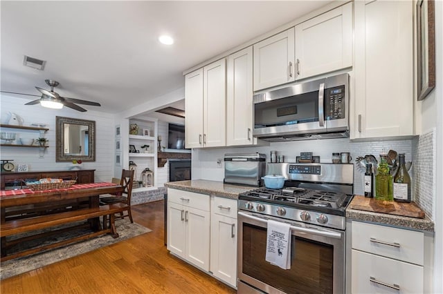 4442 Academy St, Acworth, GA 30101 - kitchen featuring appliances with stainless steel finishes, a ceiling fan, white cabinets, light wood-style floors, and recessed lighting