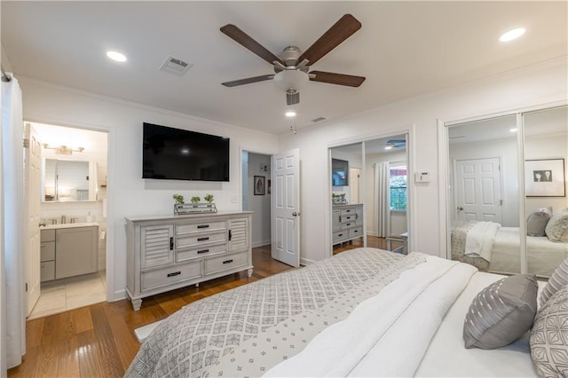 4442 Academy St, Acworth, GA 30101 - bedroom with two closets, crown molding, wood finished floors, recessed lighting, and connected bathroom