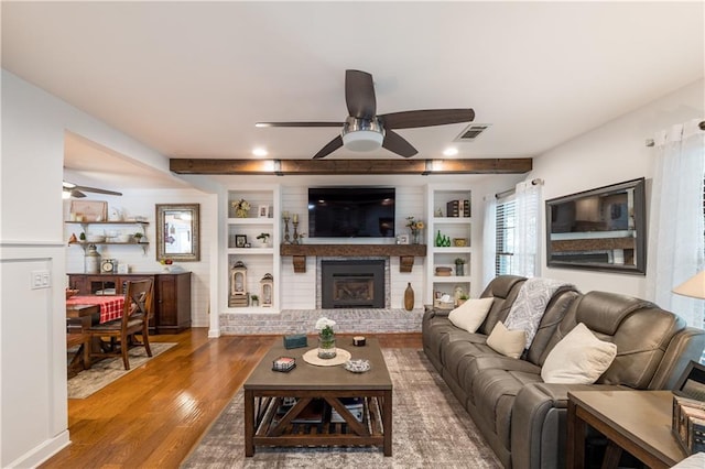 4442 Academy St, Acworth, GA 30101 - living room featuring a ceiling fan, a fireplace, wood finished floors, and built in shelves