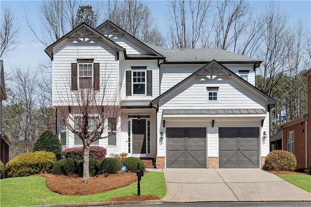 view of front facade with brick siding, a garage, driveway, and a standing seam roof