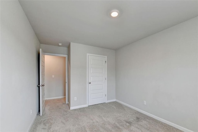 unfurnished bedroom featuring baseboards and carpet floors