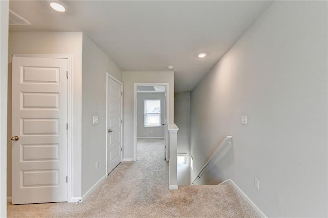 hall featuring recessed lighting, baseboards, an upstairs landing, and carpet flooring