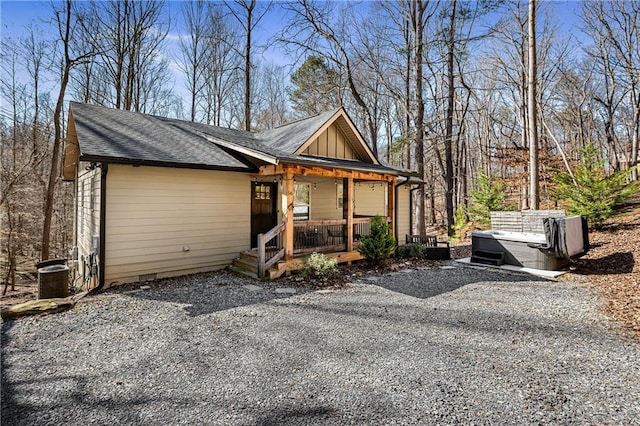 exterior space with covered porch, cooling unit, and a hot tub