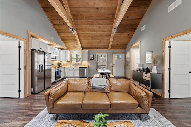 living room with beamed ceiling, dark hardwood / wood-style flooring, and wood ceiling