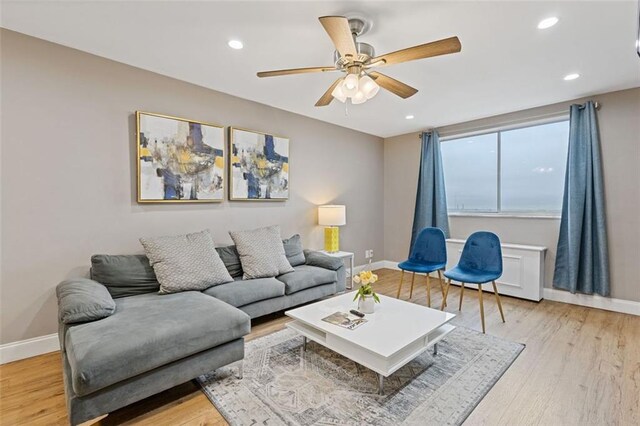 living room with light wood-style flooring, recessed lighting, baseboards, and ceiling fan